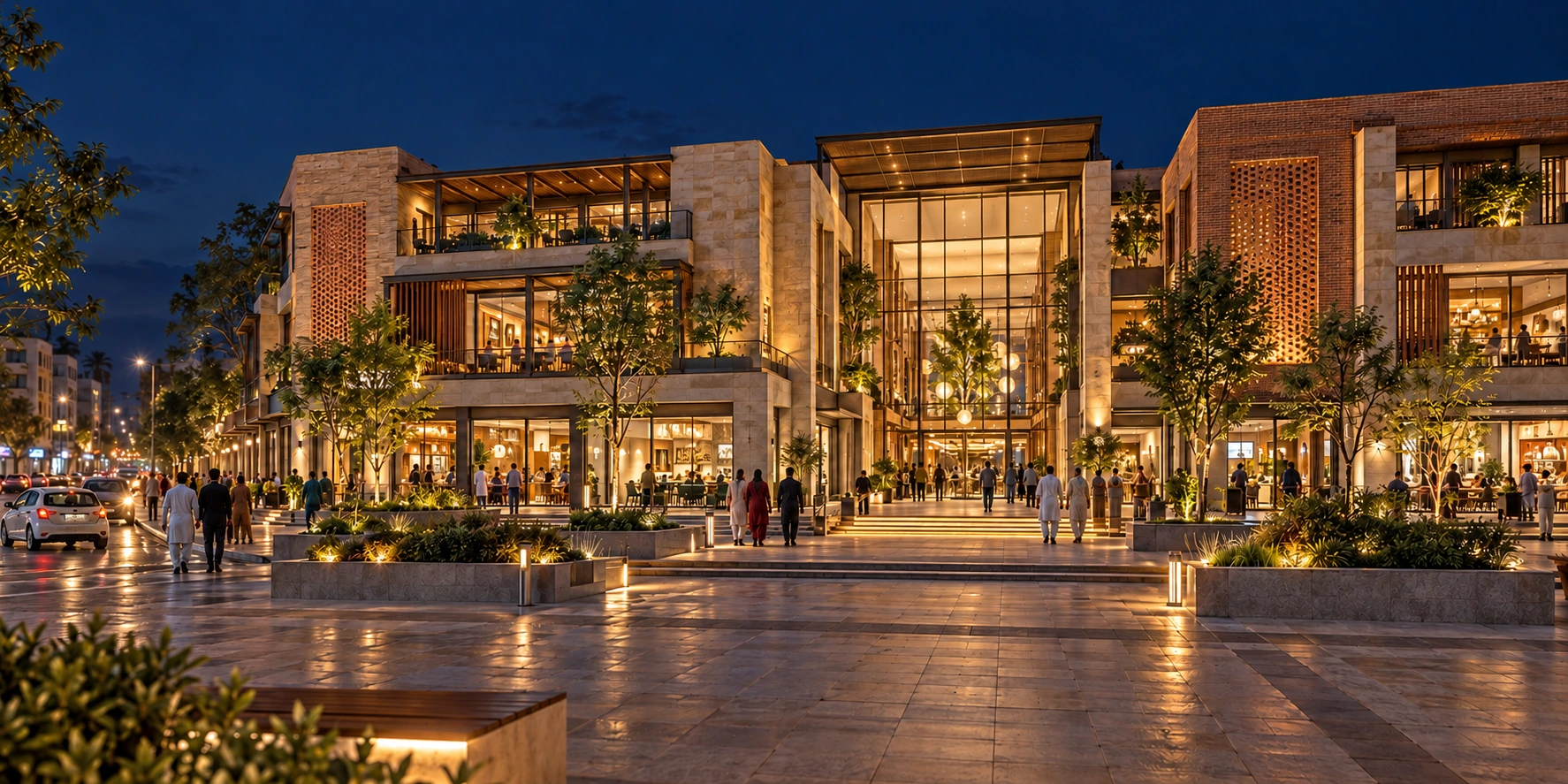 Illustrative night-time Pakistani retail destination with a glazed atrium, local brick detailing and a pedestrian forecourt